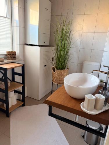 a kitchen with a large white bowl on a table at ZweiundMeer Bungalow 1 in Wiek auf Rügen