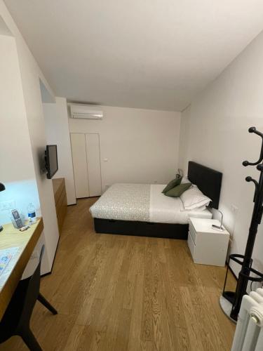 a small bedroom with a bed and a desk at Torino48 Studio Apartment in Milan