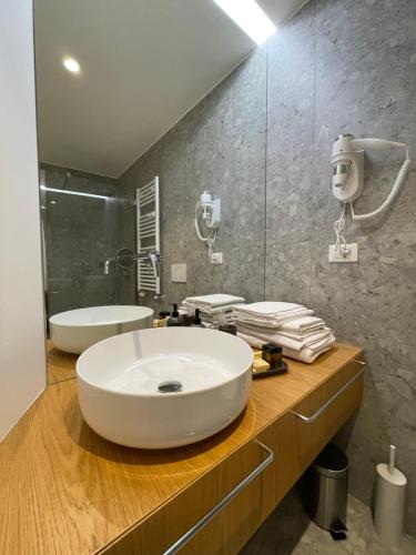 a bathroom with a large white sink and a shower at Torino48 Studio Apartment in Milan