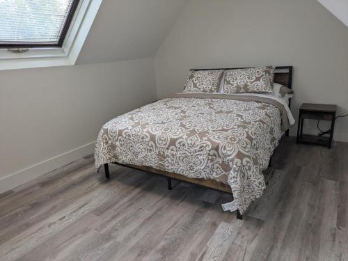 a bedroom with a bed and a wooden floor at Apartment 1 in Rockingham