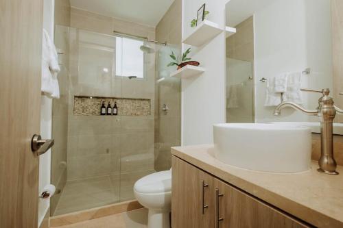 a bathroom with a toilet and a sink and a shower at Beachfront 2BR Luxury Living Walk Everywhere in Cartagena de Indias