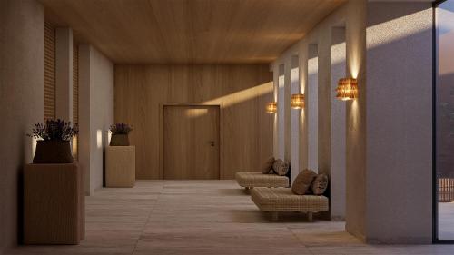 a hallway with couches and chairs in a building at The Lince Ecorkhotel Évora in Évora