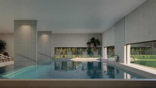 a large swimming pool in a building with water at The Lince Ecorkhotel Évora in Évora