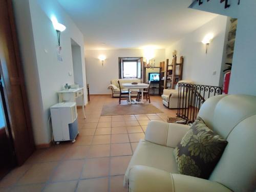 a living room with a couch and a table at Casa da Telhada Pequena in Melgaço