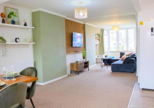 a living room with a couch and a table at Harvard House, Stylish 3 Bedroom House in Solihull 5 mins to the NEC, BHX ,JLR with free parking in Birmingham