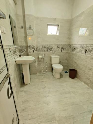 a bathroom with a toilet and a sink at Randi Guest Mirissa in Mirissa