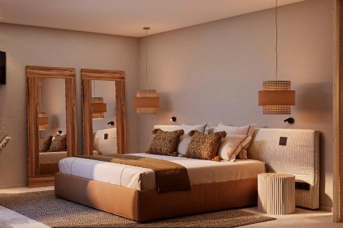 a bedroom with a large bed and a mirror at The Lince Ecorkhotel Évora in Évora