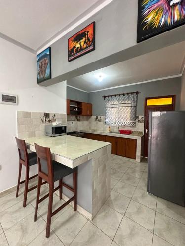 a kitchen with a table and chairs in a room at Diddy & Eddy's apartment in Malindi