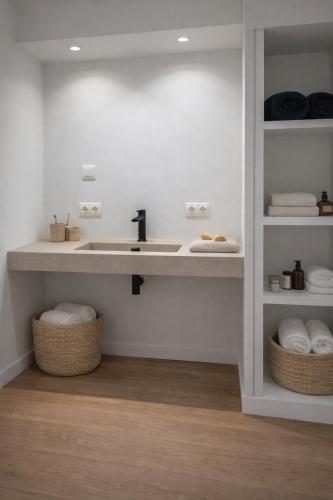a bathroom with a sink and some towels at Burgschelde 61 in Oudenaarde