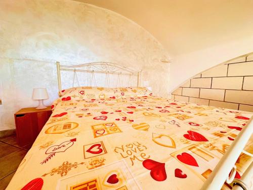 a bedroom with a bedspread with hearts on it at Perla Sul Mare in Gallipoli