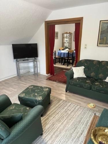 a living room with two couches and a television at Ferienwohnung Sörensen -Schleswig in Schleswig