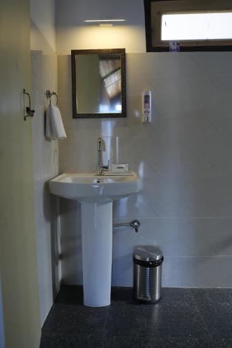 a bathroom with a sink and a mirror at Amarvi Hotel & Resort in Kalimpong