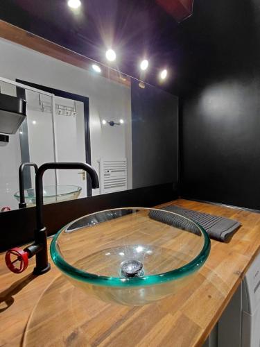 a bathroom with a hose on a wooden counter at Gites au fil des châteaux de la Loire in Saint-Georges-sur-Cher
