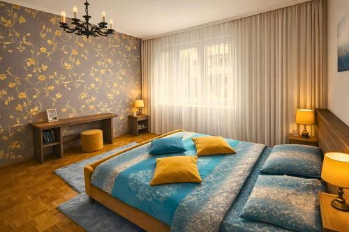 a bedroom with a bed with blue sheets and yellow pillows at Central Park Apartment in Čačak