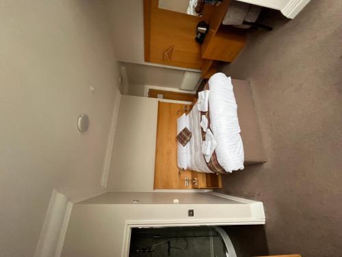 a small kitchen with a stove and a microwave at King Alfred Hotel in Barrow in Furness
