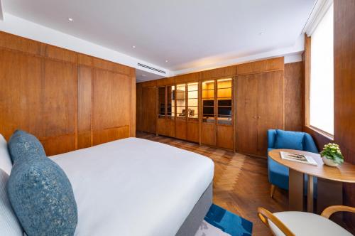 a bedroom with a bed and a table and chairs at Dao by Dorsett North London in London