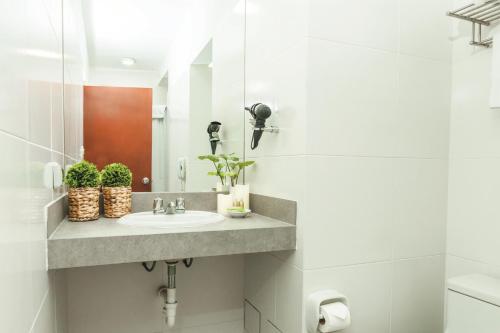 a bathroom with a sink and a mirror at La Paz Apart Hotel in Lima