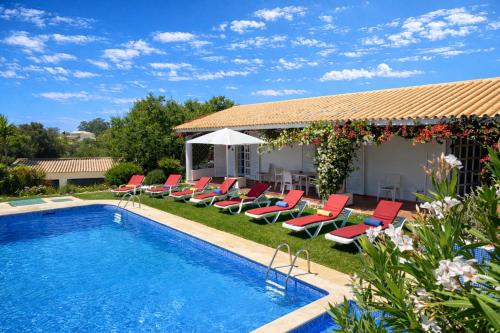 a swimming pool with lounge chairs and a house at Espraguina - Private Pool - 16 Guests - Loulé in Loulé