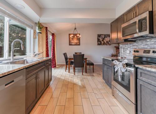 a kitchen with wooden cabinets and a dining room at Modern 4 Bedroom home with large, fenced backyard, Pet friendly - 20 mins to DFW Airport in Flower Mound