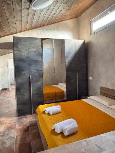 a bedroom with two beds and a large mirror at Hotel Urban By Giulia in Pozzolo Formigaro