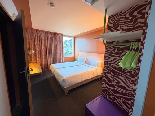 a hotel room with a bed and a room with at IBIS STYLES ALES CENTRE in Alès