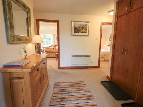 a living room with a wooden dresser and a living room at Thrang View in Ambleside