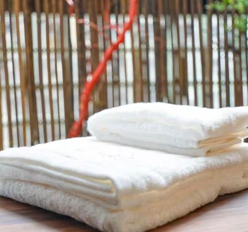 two white pillows sitting on top of a table at Momotarou Stay in Yokohama