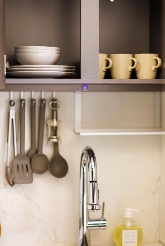 a kitchen counter with utensils and a sink at 케이 코지 하우스 - 스튜디오 in Seoul