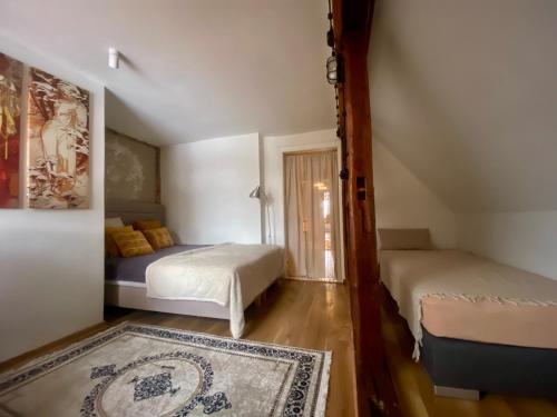 a small bedroom with two beds and a rug at Feel-Harmonia w Nowym Kawkowie in Nowe Kawkowo