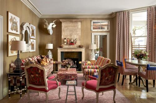 a living room with a couch and chairs and a fireplace at Knightsbridge Hotel, Firmdale Hotels in London