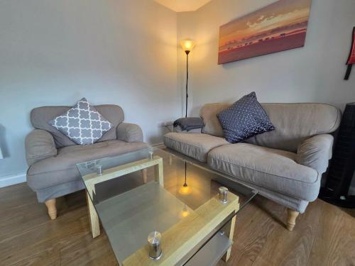 a living room with two couches and a coffee table at 4a Smart Apartments in Newark-on-Trent