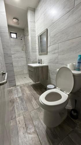 a bathroom with a toilet and a sink and a shower at Casa Completa in Rancho San Pedro