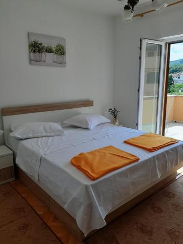 a bedroom with a bed with two towels on it at Apartments Nela in Jelsa