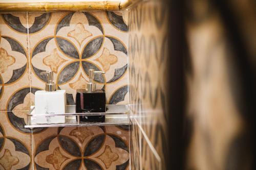 a bathroom with two candles on a wall at First Love Room in Thưy Ðầm