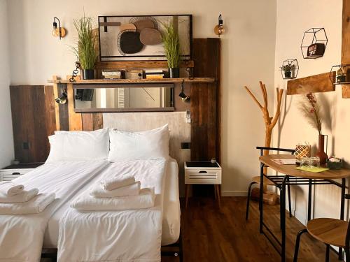 a bedroom with a white bed with towels on it at Stanza in sondrio Coel in Sondrio