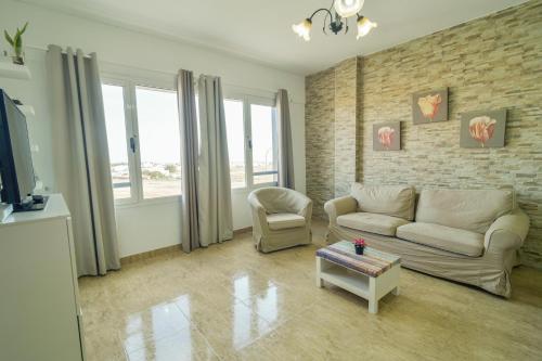 a living room with a couch and a chair at Edificio Prieto VIV 2A in Puerto del Rosario