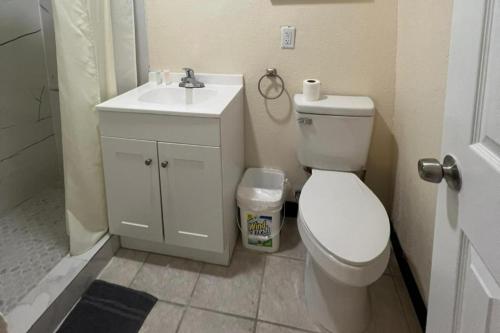 a bathroom with a white toilet and a sink at Cross City Motel by Hotel O US 19 in Cross City