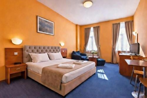 a hotel room with a bed and a desk at Sveta Sofia Hotel in Sofia