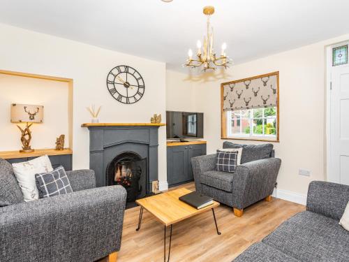 a living room with two couches and a fireplace at Court Terrace in Ripon