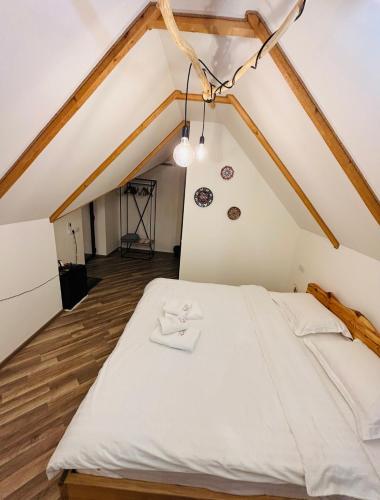 a bedroom with a white bed in a attic at Montis Resort in Yeghegis
