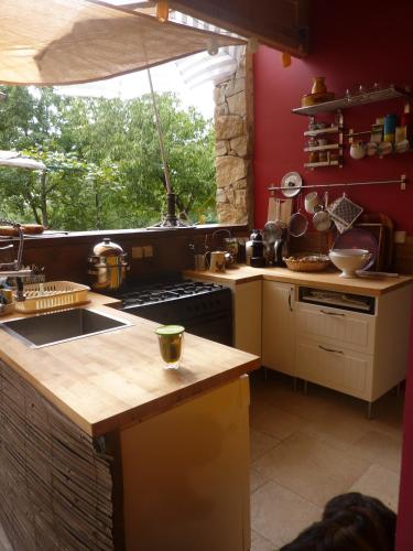 a kitchen with a sink and a stove top oven at La Parenthèse ardéchoise - Spa et billard - Se ressourcer entre ville et forêt in Privas