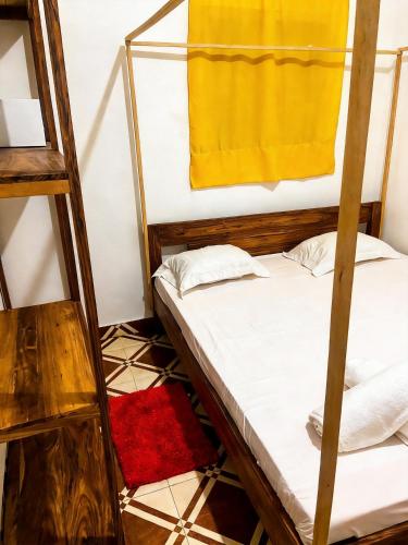 a room with two bunk beds and a red rug at Bee Rooms Nosy be in Ambatoloaka