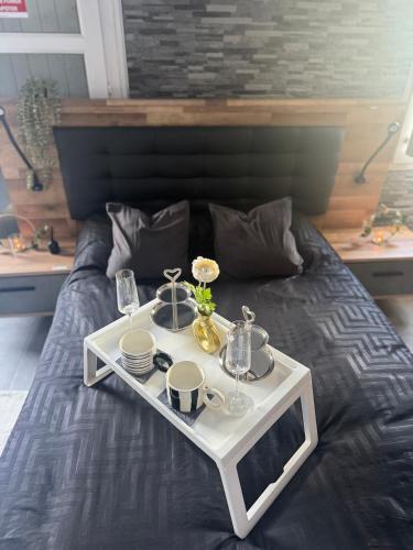 a tray with food and drinks on a bed at Sisters spa room in Portet-sur-Garonne