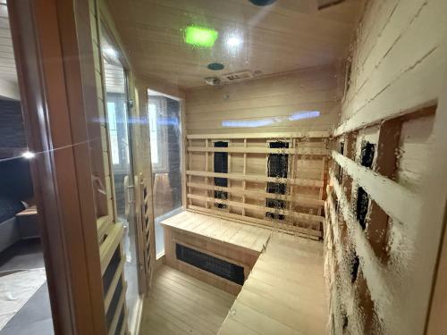 a walk in shower with a bench in a room at Sisters spa room in Portet-sur-Garonne