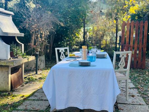 a table with a white table cloth and plates on it at Dimora dei Passi Lenti in Montegranaro