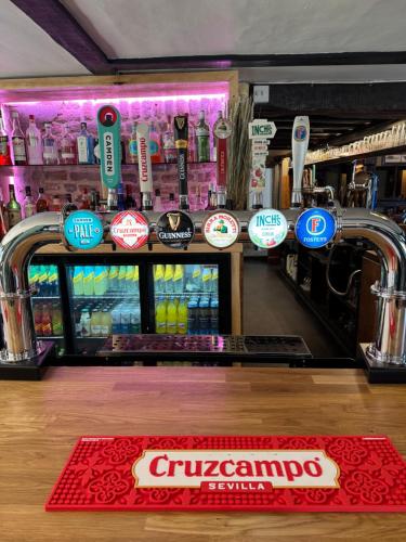 a bar with a counter with signs on it at Country inn in Staple