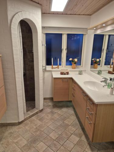 a large bathroom with a shower and a sink at Marias house i Agger in Vestervig