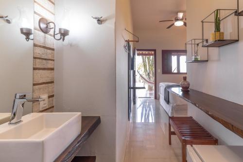 a bathroom with a sink and a counter at Pousada Rávis - Café e Descanso in Sabará