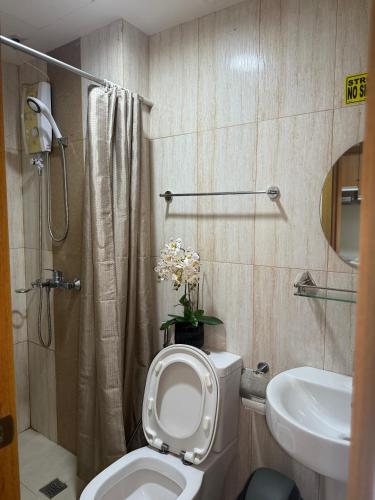 a bathroom with a toilet and a sink at Cozy Condo in Ermita Manila near St Lukes Medical Center and US Embassy in Manila