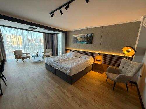 a bedroom with a bed and a desk and a chair at Hotel Martex in Płońsk